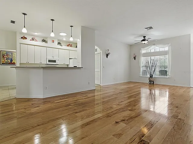 a kitchen with a sink cabinets and wooden floor