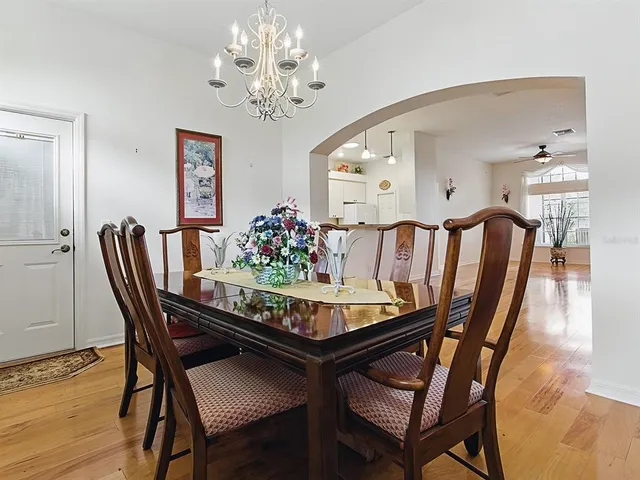 a view of a big room with wooden floor and windows