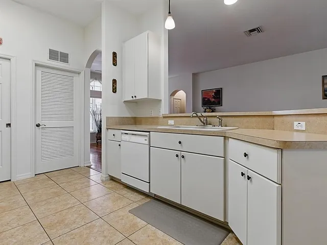 a spacious bathroom with a tub sink and mirror