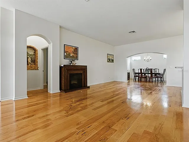 a view of a livingroom with wooden floor and a ceiling fan