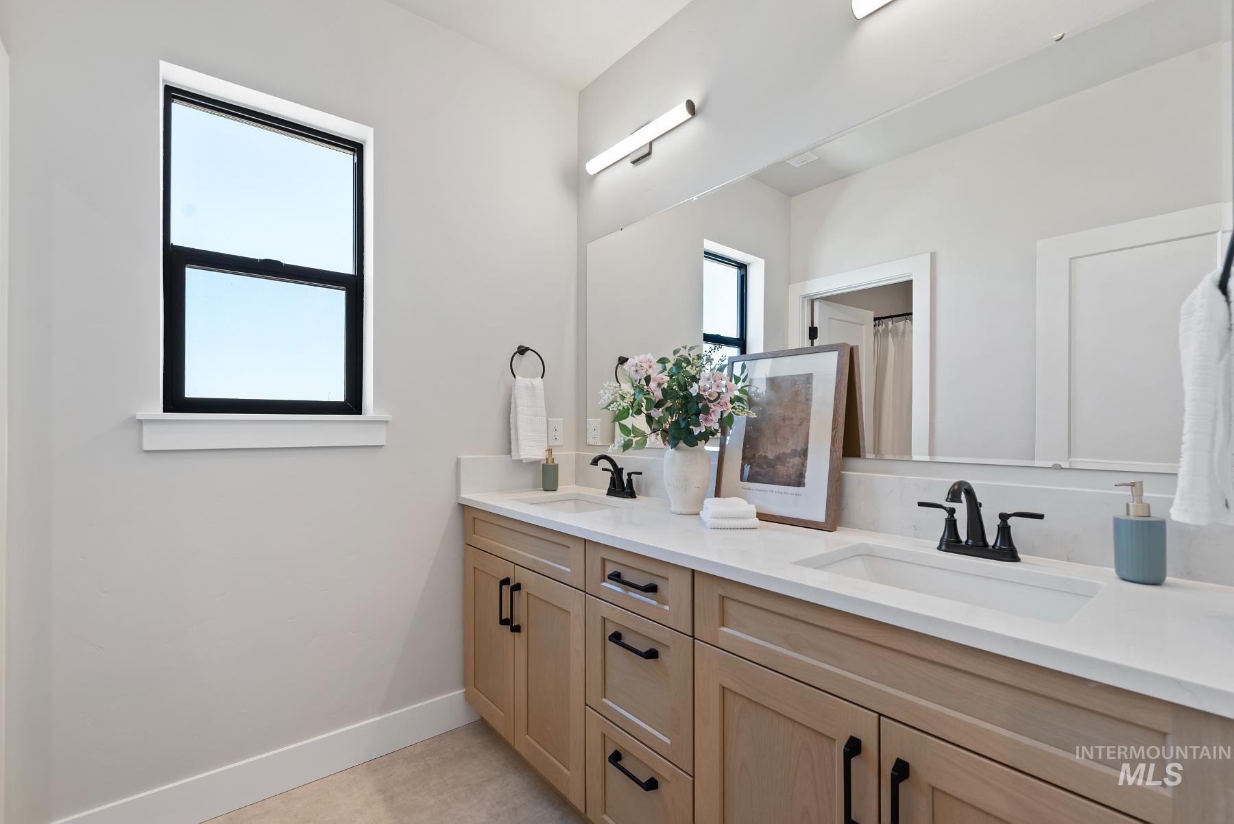 8410 West Graye Street, Unit ALPINE Meridian, ID 83646 - Photo 25 of 45 Spacious room with wood-finish flooring, featuring contemporary white barn doors with black hardware, a flush-mount ceiling light, and a single window
