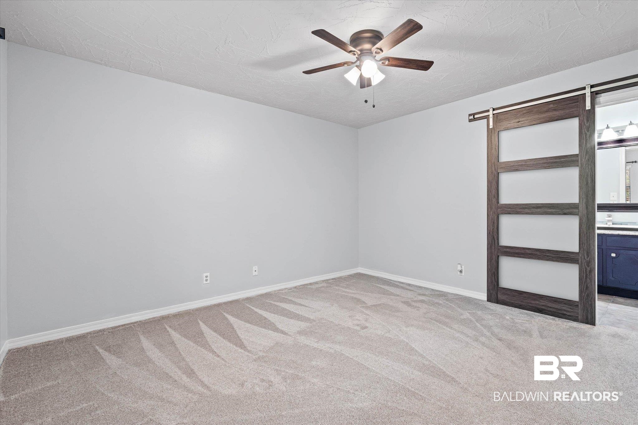 500 Grant Street, Unit C210 Daphne, AL 36526 - Photo 15 of 26 Spacious room featuring light gray walls, textured ceiling, and plush gray carpet