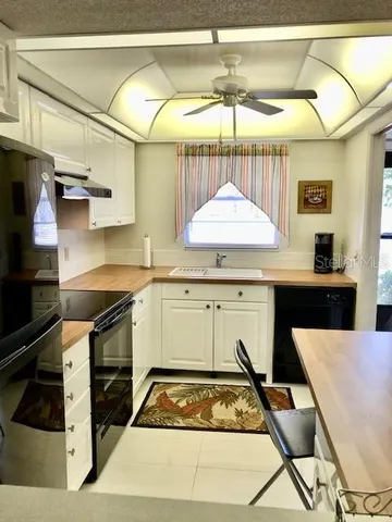 a kitchen with a stove a sink and a refrigerator