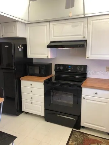 a kitchen with granite countertop a stove and a cabinet