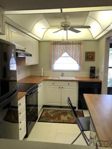 a kitchen with a sink a stove and a refrigerator
