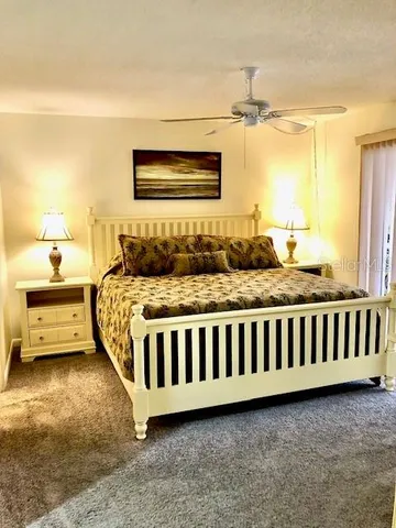 a bedroom with a bed and a night stand