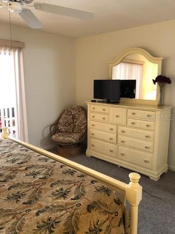 a bedroom with a bed and a television