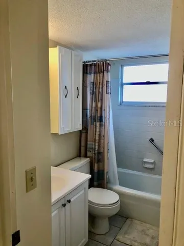 a bathroom with a toilet a sink and bathtub