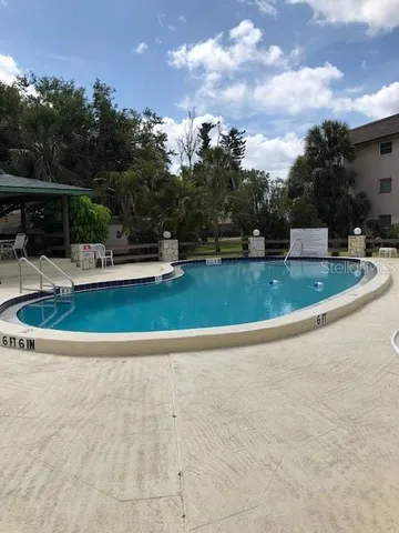 a view of a swimming pool with a yard