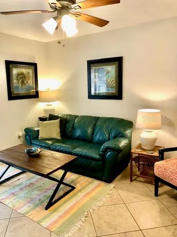 a living room with furniture and a lamp
