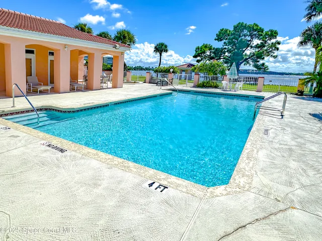 a view of a patio with table and chairs with wooden fence