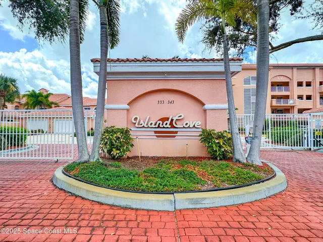 a view of a house with a small yard and wooden fence