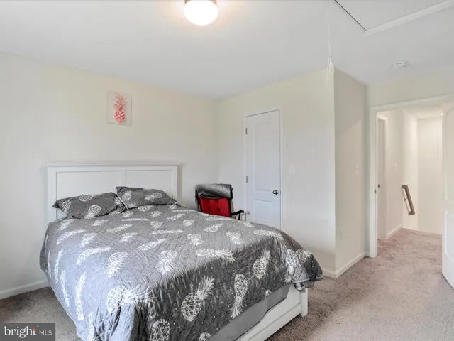 a bedroom with a bed and a lamp