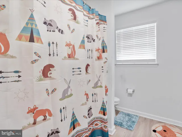 a bathroom with a bathtub and a window