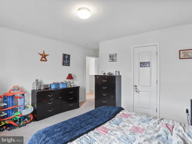 a bedroom with a bed and a dresser