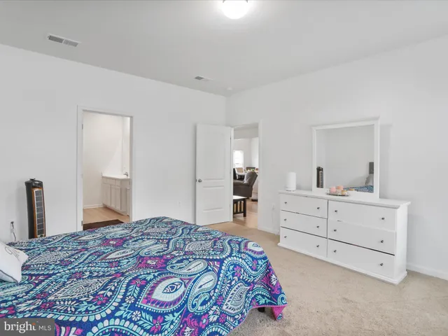 a bedroom with a bed and a dresser