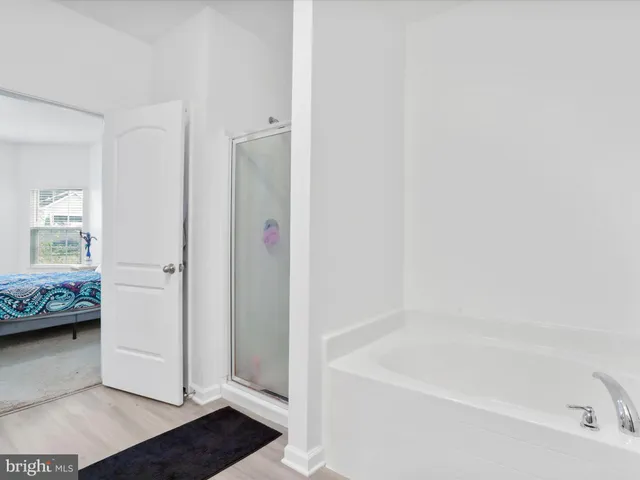 a white bath tub sitting in a en suite bathroom