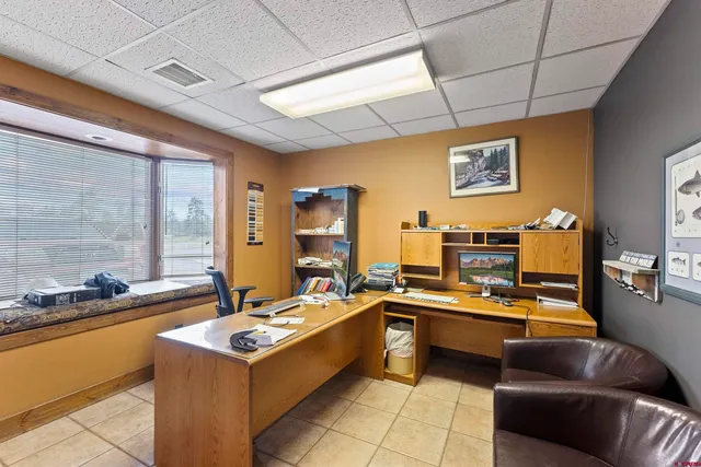 a work room with furniture and wooden floor