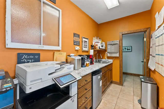 a room with furniture pool table and windows