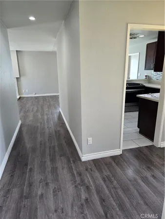 a view of a kitchen from a hallway