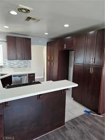 a kitchen with stainless steel appliances a refrigerator and a microwave