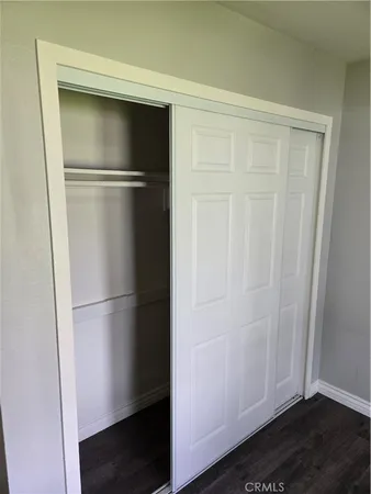 a empty refrigerator with wooden floor