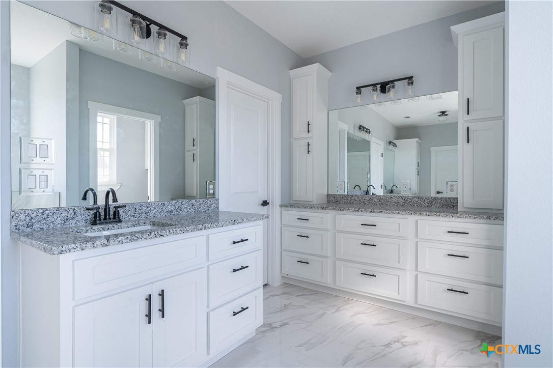1000 Black Ankle Road Lockhart, TX 78644 - Photo 15 of 40 a bathroom with a granite countertop double vanity sink mirror bathtub and