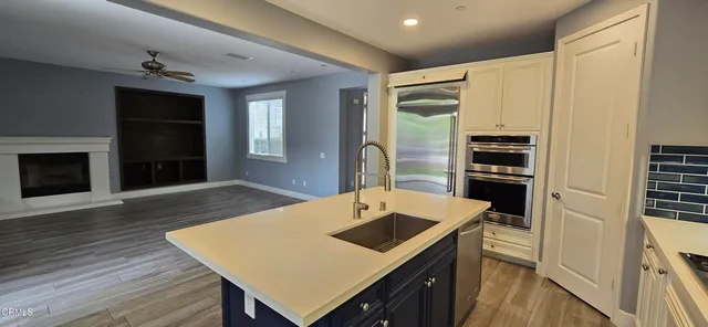 a kitchen that has a table chairs and wooden floor