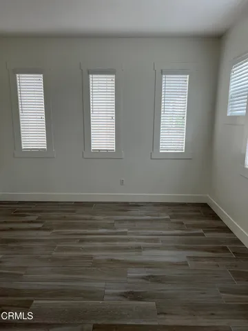 a view of a room with wooden floor and window