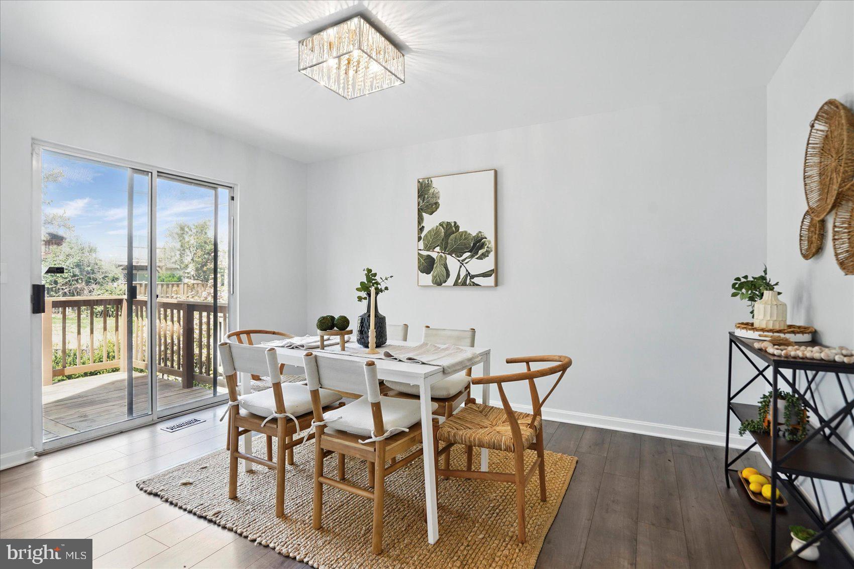 7020 Storch Lane Lanham, MD 20706 - Photo 14 of 44 a view of a dining room with furniture a chandelier and wooden floor