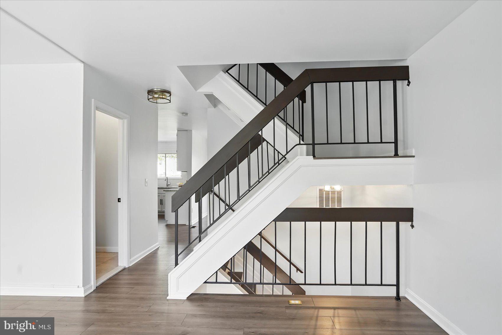 7020 Storch Lane Lanham, MD 20706 - Photo 20 of 44 a view of staircase with railing and white walls