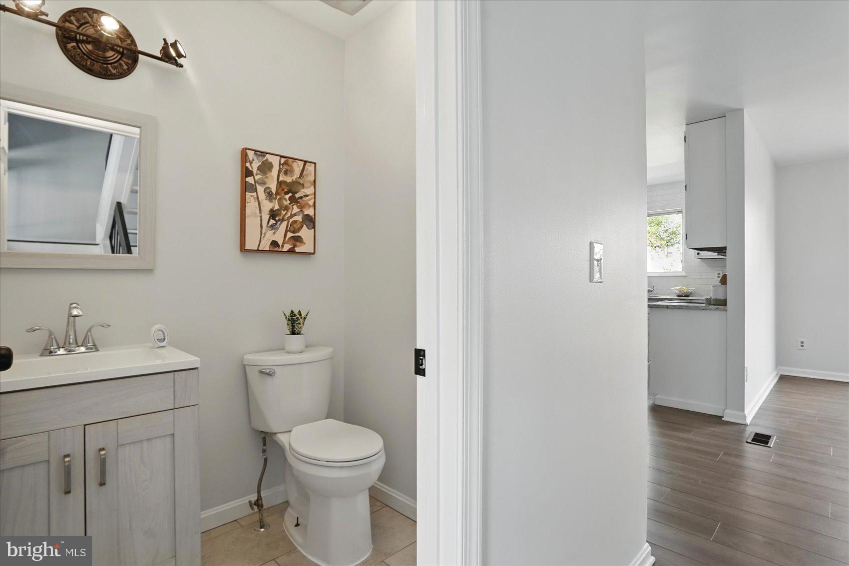 7020 Storch Lane Lanham, MD 20706 - Photo 22 of 44 a bathroom with a toilet a sink and mirror