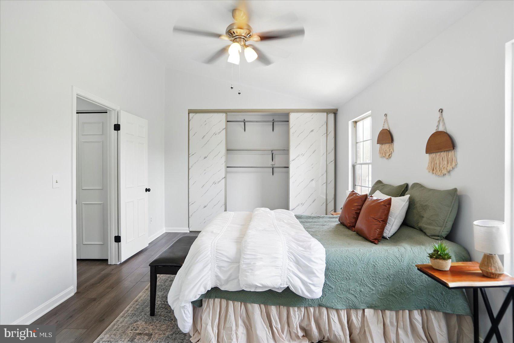 7020 Storch Lane Lanham, MD 20706 - Photo 28 of 44 a bedroom with a bed and wooden floor