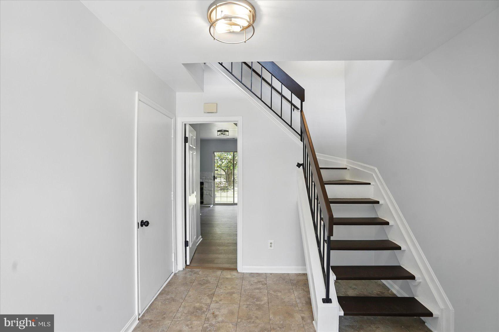 7020 Storch Lane Lanham, MD 20706 - Photo 3 of 44 an entryway with a white walls and stairs