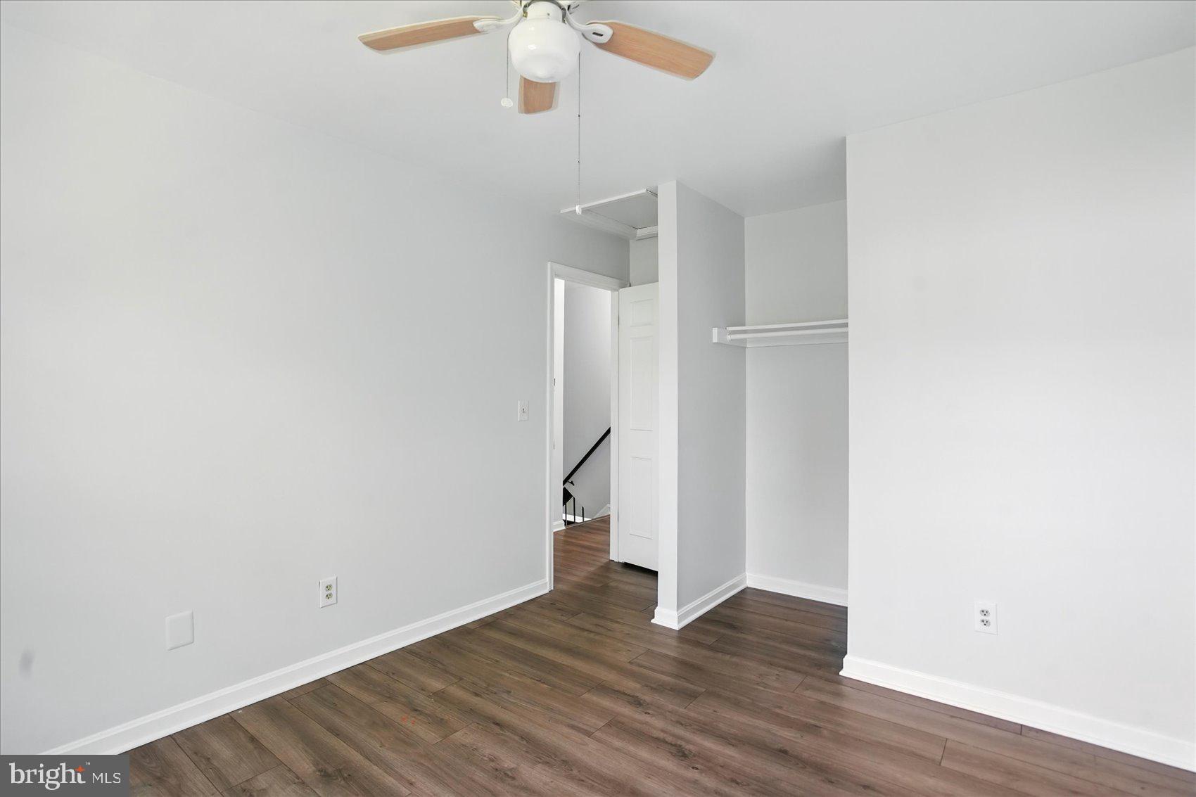 7020 Storch Lane Lanham, MD 20706 - Photo 31 of 44 an empty room with wooden floor and ceiling fan
