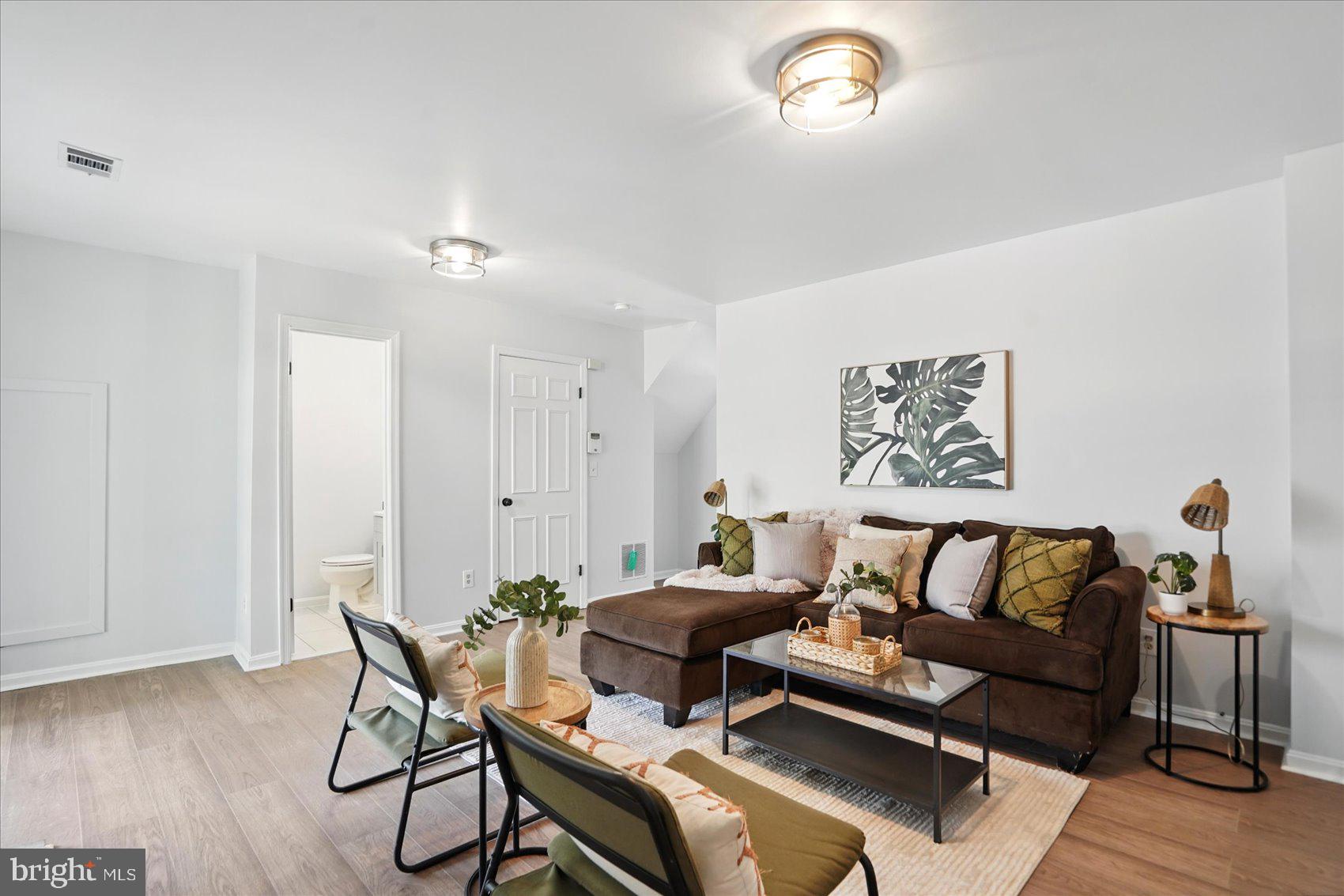 7020 Storch Lane Lanham, MD 20706 - Photo 5 of 44 a living room with furniture and a wooden floor