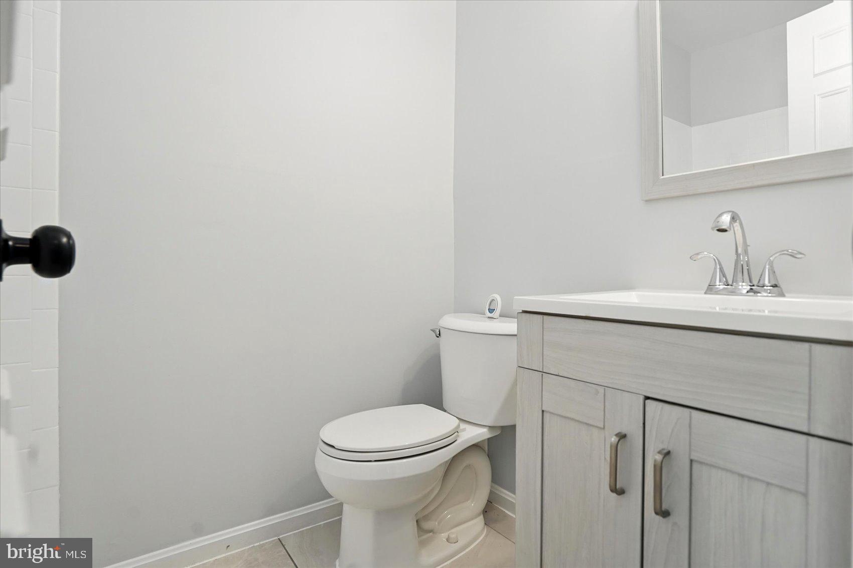 7020 Storch Lane Lanham, MD 20706 - Photo 7 of 44 a bathroom with a sink a toilet and a mirror
