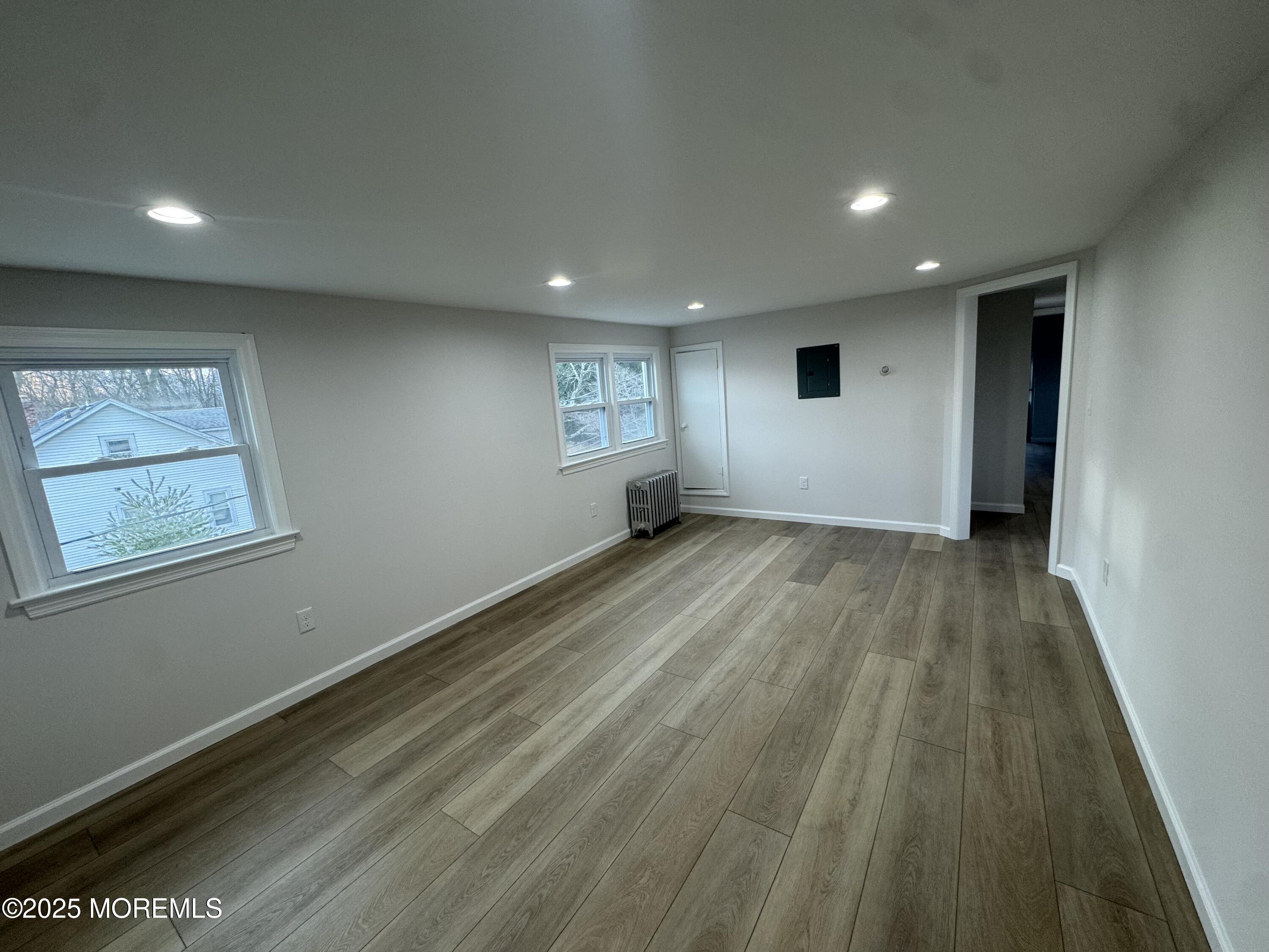 259 Matawan Avenue Matawan, NJ 07747 - Photo 18 of 46 an empty room with wooden floor and windows