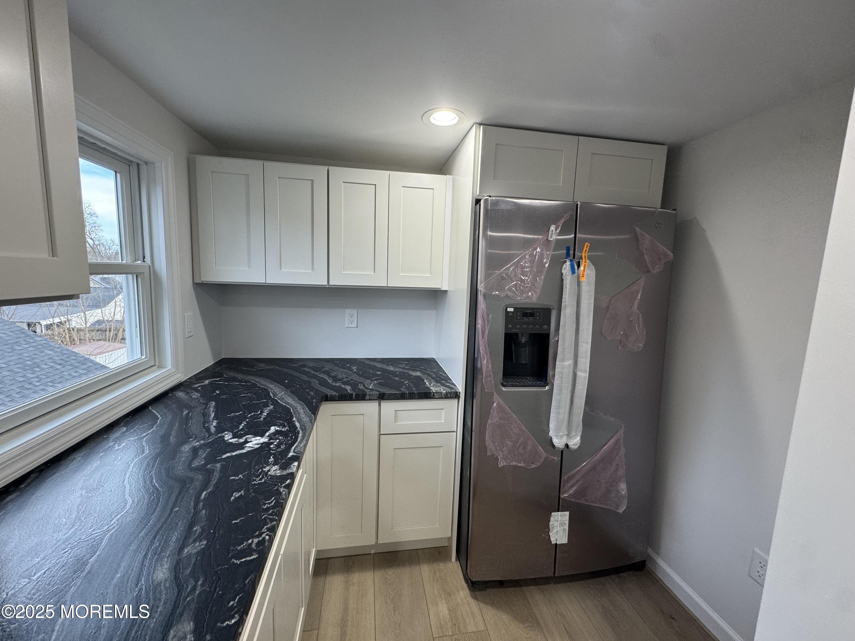 259 Matawan Avenue Matawan, NJ 07747 - Photo 22 of 46 a kitchen with a refrigerator and cabinets