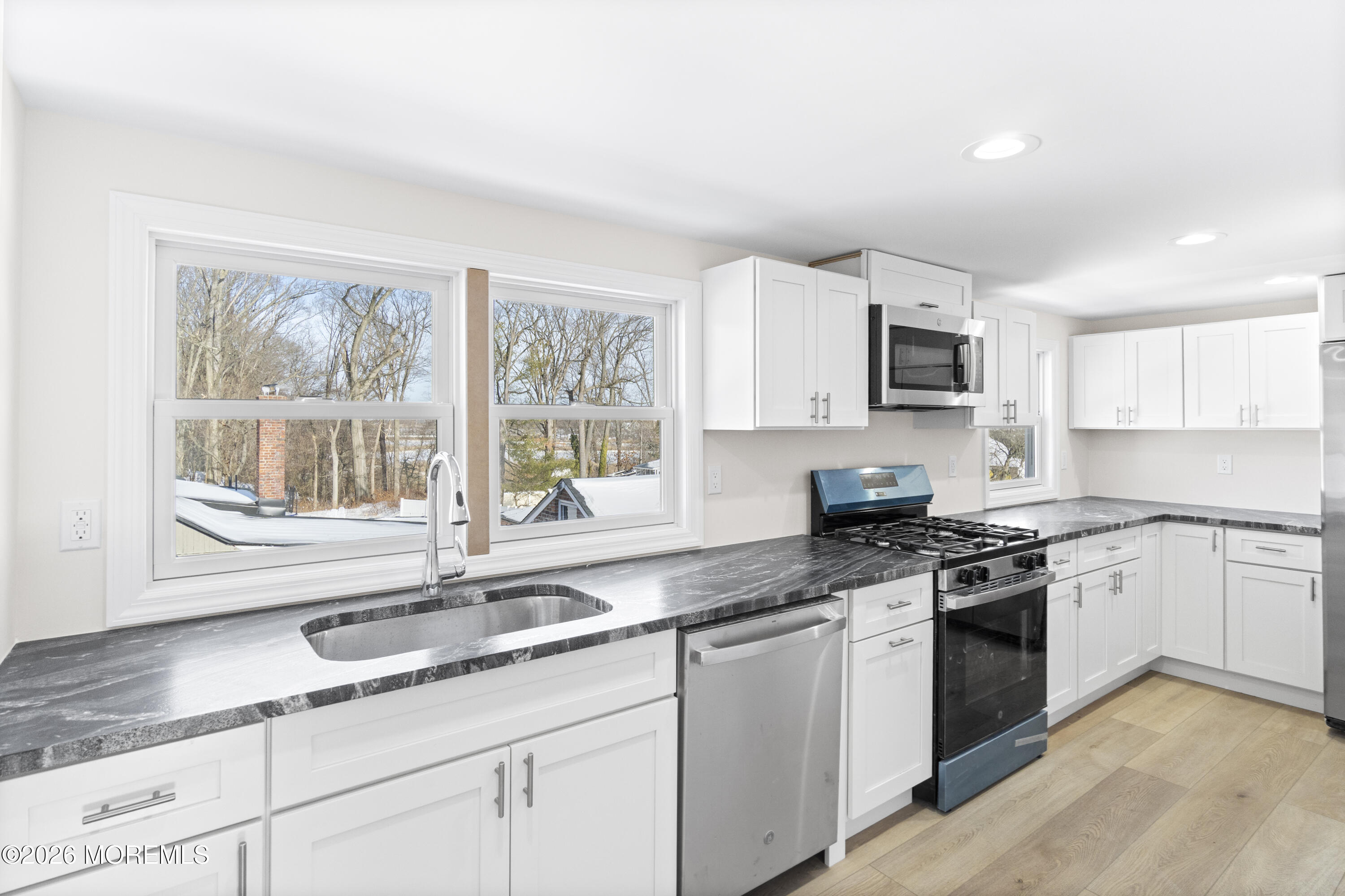 259 Matawan Avenue Matawan, NJ 07747 - Photo 5 of 46 a kitchen with granite countertop white cabinets a sink a window and stainless steel appliances