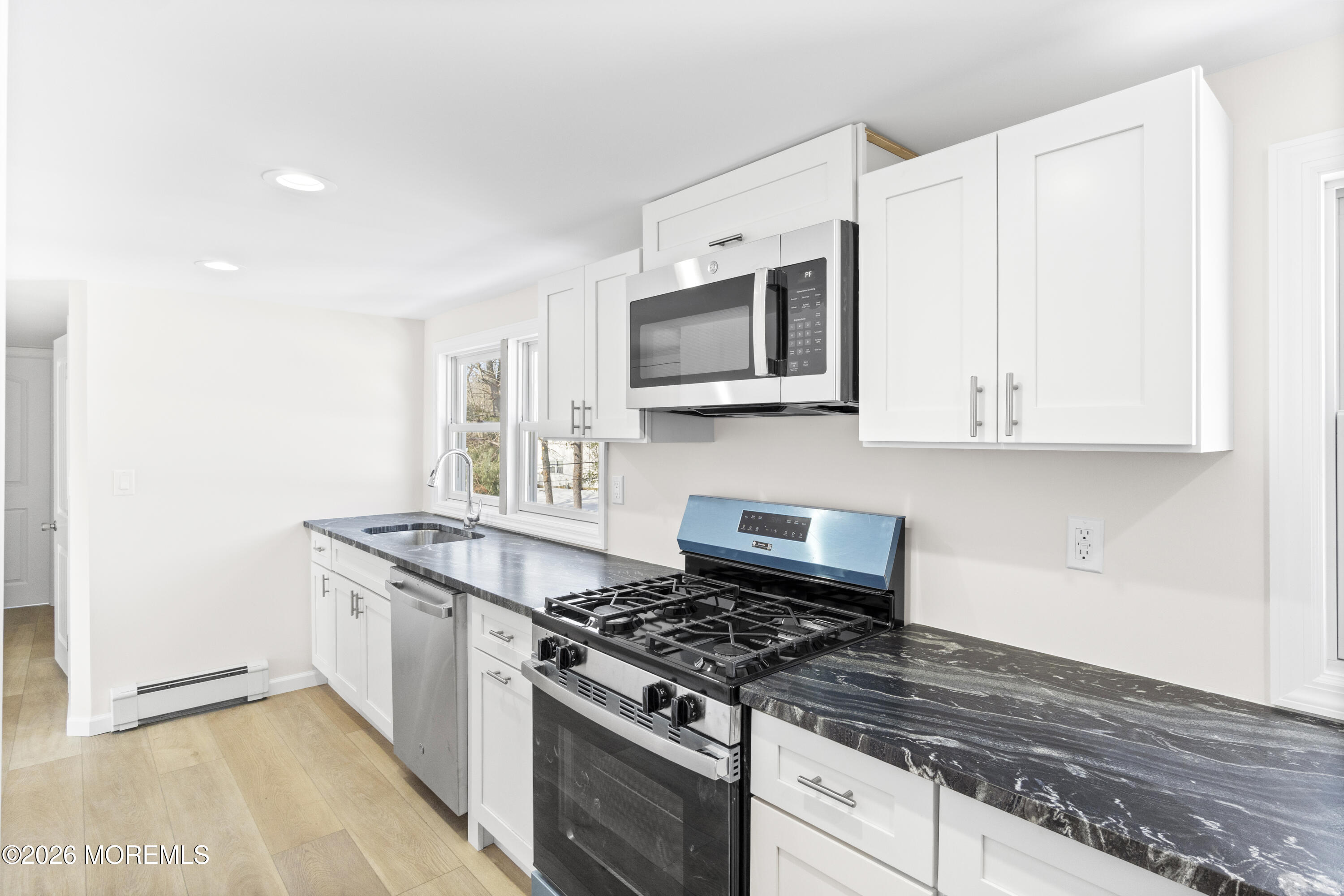 259 Matawan Avenue Matawan, NJ 07747 - Photo 6 of 46 a kitchen with stainless steel appliances granite countertop a stove and a microwave