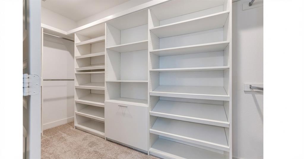 651 Watters Road, Unit 1206 Allen, TX 75013 - Photo 14 of 28 Custom designed closet system in primary bedroom closet.