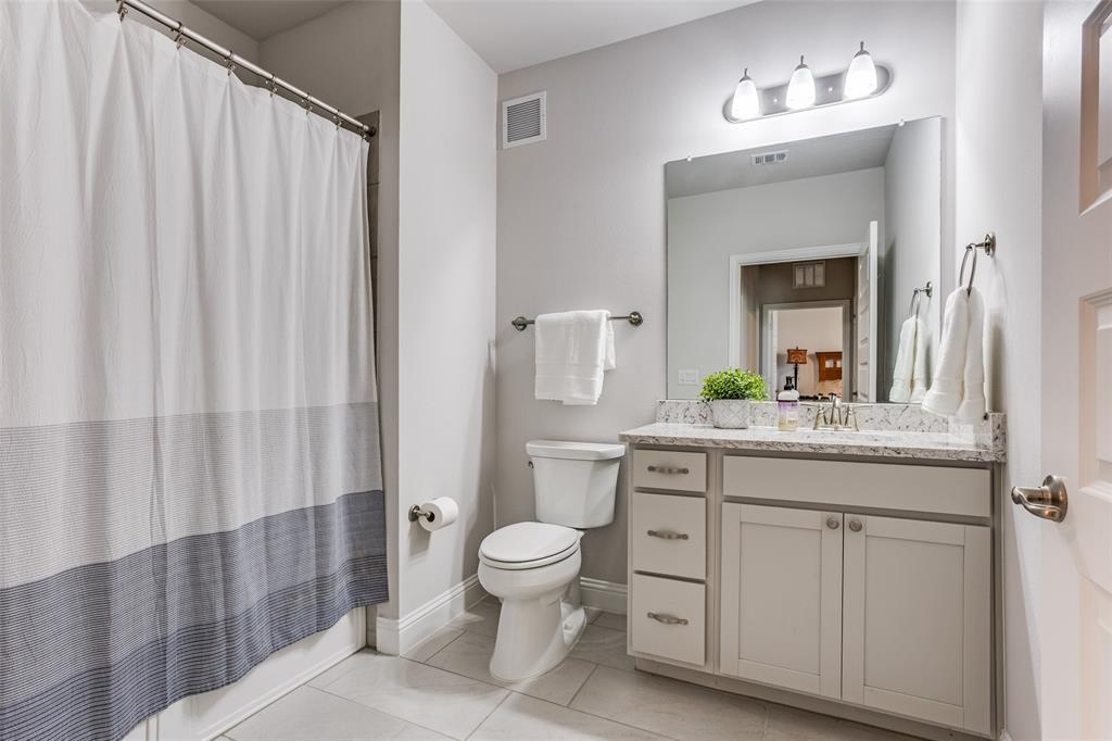 651 Watters Road, Unit 1206 Allen, TX 75013 - Photo 20 of 29 a bathroom with a granite countertop sink a toilet and a mirror