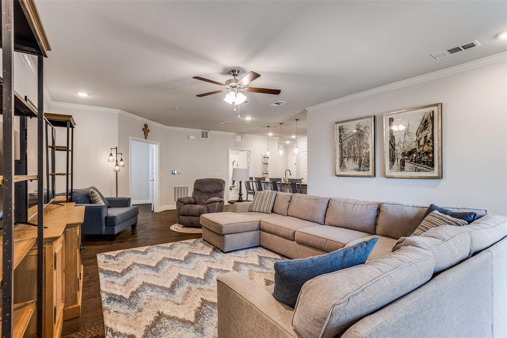 651 Watters Road, Unit 1206 Allen, TX 75013 - Photo 7 of 29 a living room with furniture ceiling fan and a rug