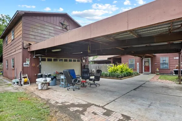 a view of a patio with table and chairs under an umbrella