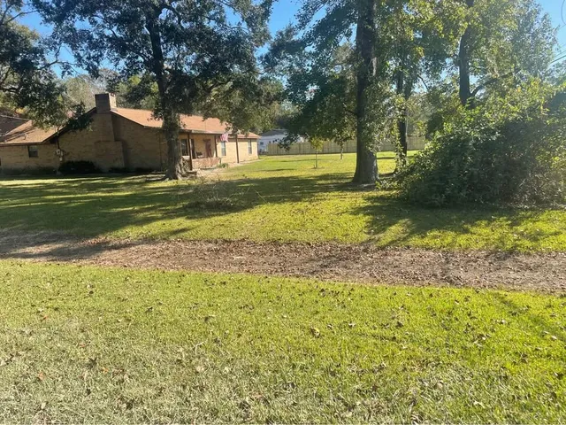 a view of a swimming pool and a yard