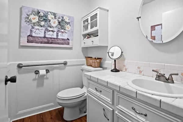 a bathroom with a toilet a sink and mirror