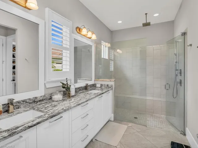 a bathroom with a granite countertop sink mirror and double