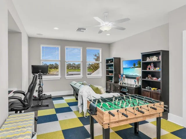 a living room with furniture and a dining table with rug