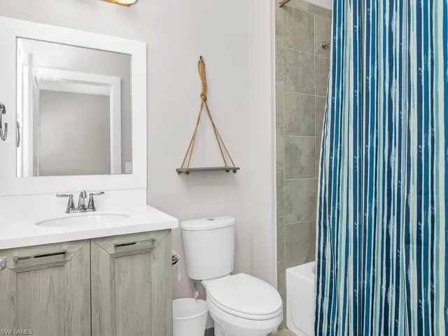 a bathroom with a toilet a sink and a mirror